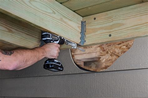 metal attached inside the house to decking|connecting deck to house.